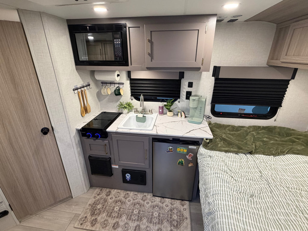  and mountain-themed decor.|Spacious rv rental interior: light wood cabinets — photo 11
