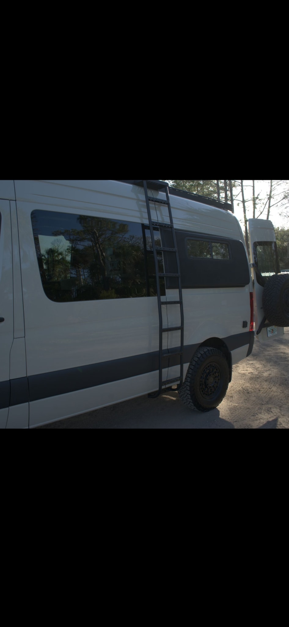  and a central control panel in a camper van.|Modern rv rental kitchen with light wood cabinets — photo 12