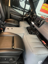 RV rental ingenuity: An inflatable mattress fills the front cab of a van, creating a comfortable bed for road trips.