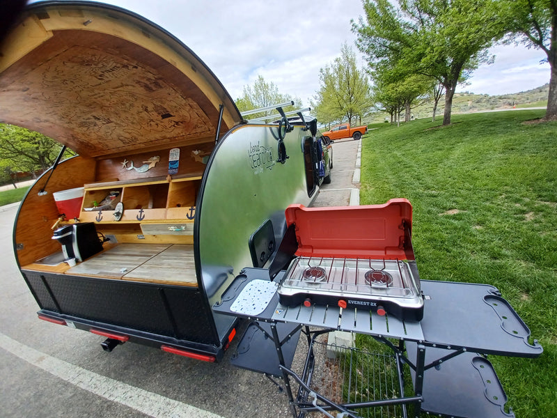This RV rental teardrop trailer offers a unique outdoor kitchen with a pirate map ceiling and portable stove for your next adventure. — photo 6