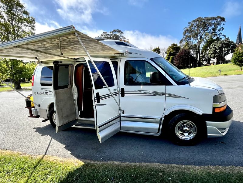  and a 15 amp current limit.|Inside an RV rental: off-grid power system with a Victron inverter/charger & two LifeBlue batteries.|RV rental backup camera display: "Check Surroundings Before Backing Up" text — photo 15