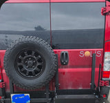 This red RV rental van features a rear-mounted spare tire, 'SOLIS' branding, & a sturdy gear rack, perfect for road trip adventures.