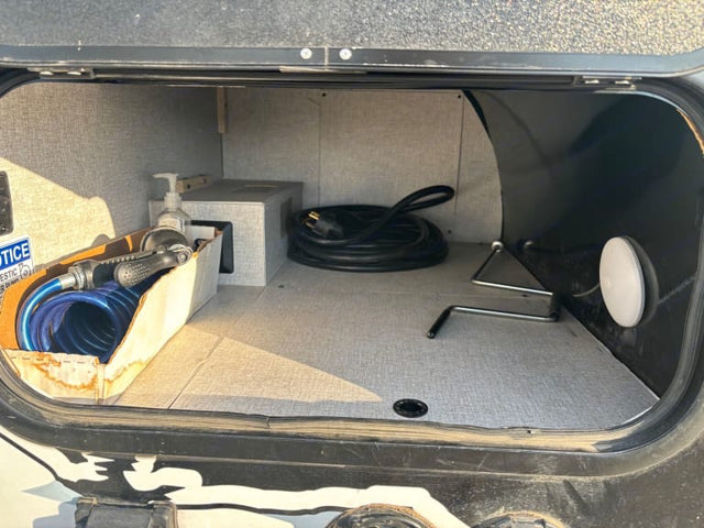  and a door to nature.|Bright RV rental interior with white seating