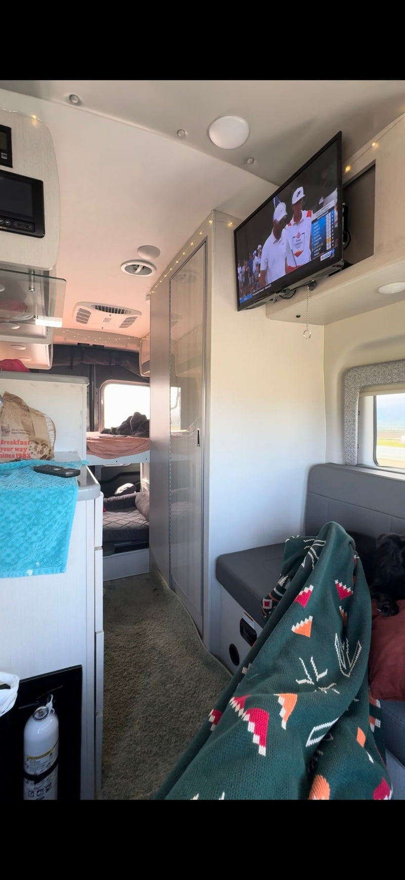  reflecting the trees in its windows on a damp road.|Dashboard view from an RV rental — photo 7