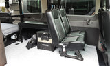 Inside an rv rental: custom van conversion with comfortable seating, bed, and integrated fridge/power station.