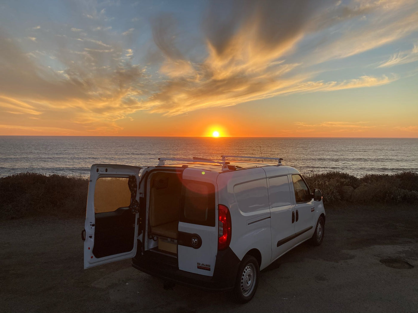  and a strapped water tank.|A white RV rental van with solar panels