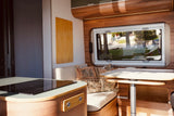 Step inside this cozy RV rental, featuring a modern kitchen, comfortable seating, and a dining area with a view.