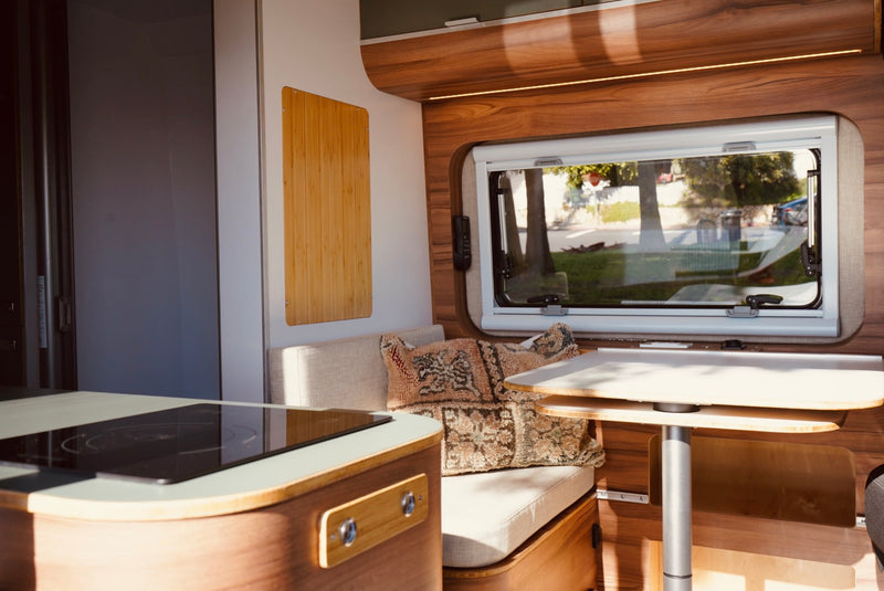  and comfy seating area by the window.|Step inside this modern RV rental! Features a sleek kitchen — photo 15