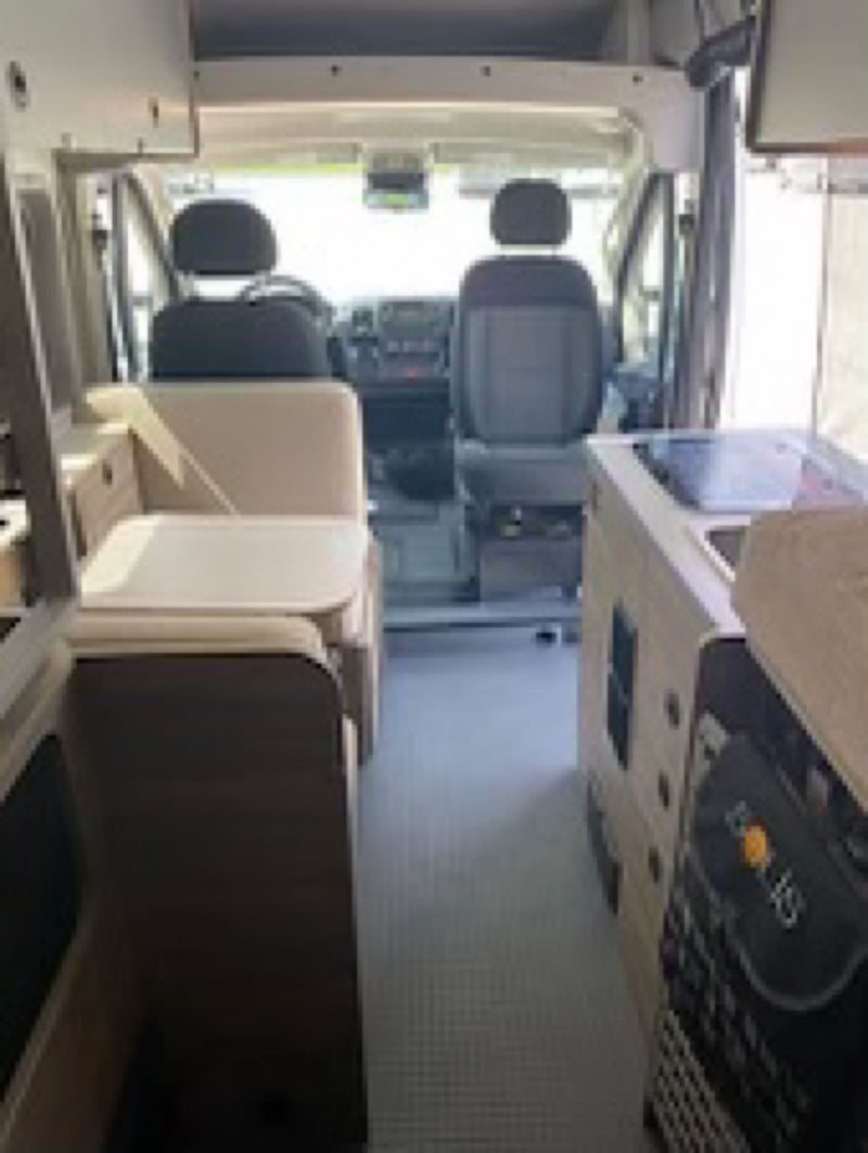  inviting outdoor relaxation.|Comfortable RV rental interior: A cozy bed with white and green bedding — photo 6