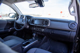 Toyota Tacoma interior: modern dashboard, steering wheel, and infotainment. Ideal for your next RV rental adventure.