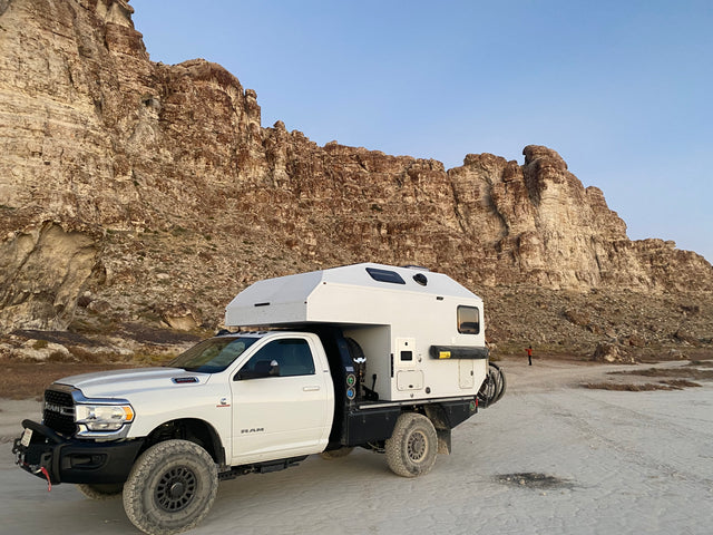 An adventure-ready Ram truck camper, perfect for RV rental off-road trips. Explore rugged landscapes with this expedition vehicle.