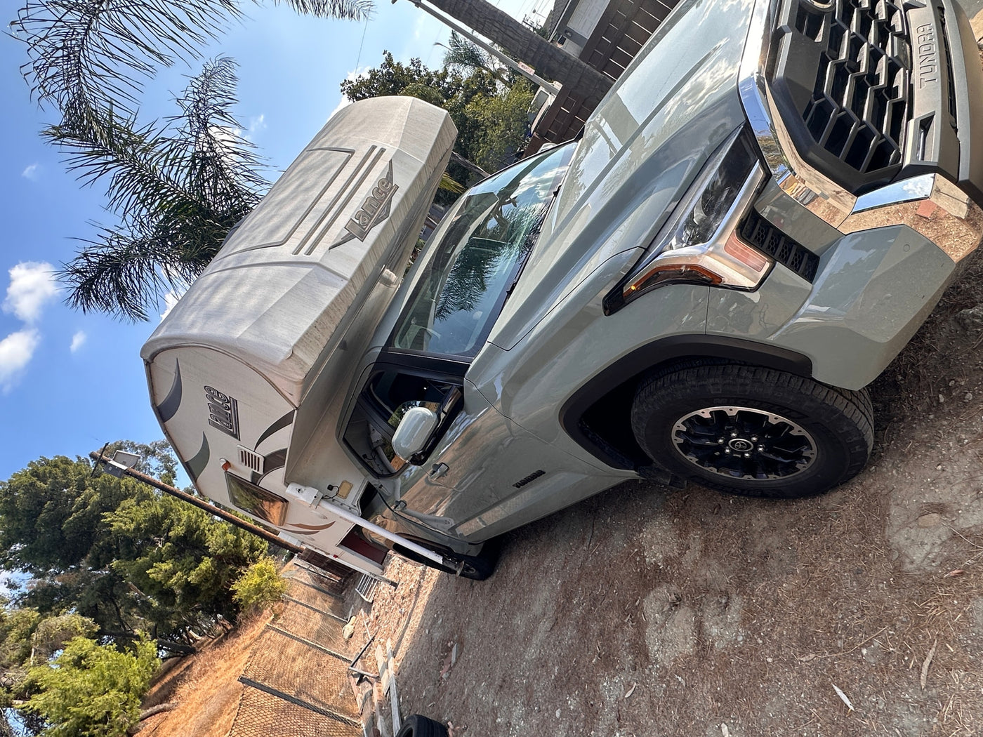  ideal for an RV rental adventure or outdoor travel under blue skies.|A light green Toyota Tundra pickup truck with a Lance truck camper. Ideal for an RV rental adventure!|A light green Toyota Tundra pickup truck with a Lance truck camper loaded in its bed — photo 12