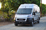 A silver Winnebago camper van (RAM ProMaster) on a gravel road, ideal for an RV rental adventure.