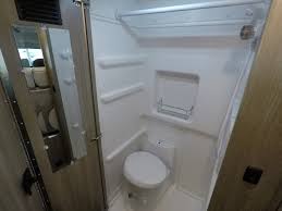  ideal for camping adventures.|RV rental camper van interior. Swivel front seats face a table and rear bench — photo 7