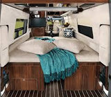 RV rental interior shows a cozy bed, side windows, and a TV. This comfortable camper van is ready for travel adventures.