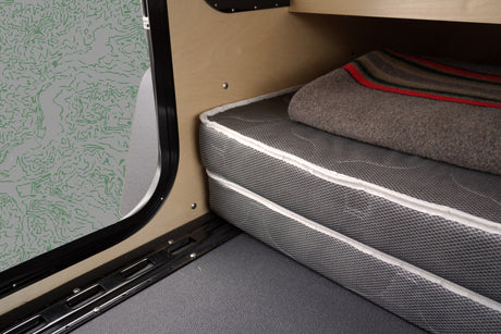  and license plate area on a black textured surface. ALPHA branding visible.|Underside view of an RV rental's robust rear hitch receiver