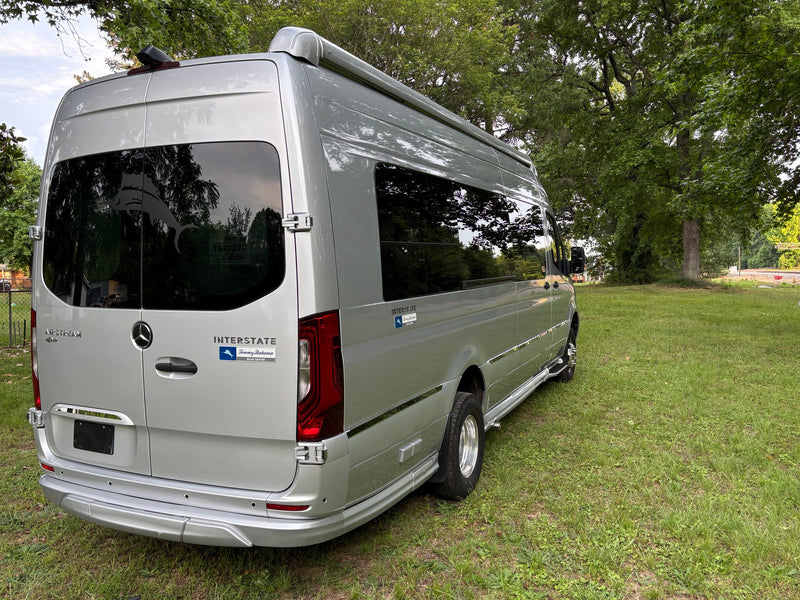  perfect for your next adventure.|Silver Airstream Interstate touring coach RV parked on grass near tracks — photo 9