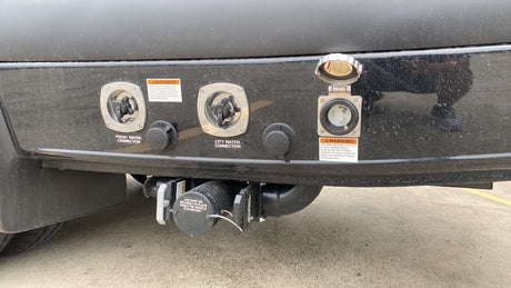 RV rental utility panel: fresh water, city water, 30A power, and waste drain connections for full hookups.