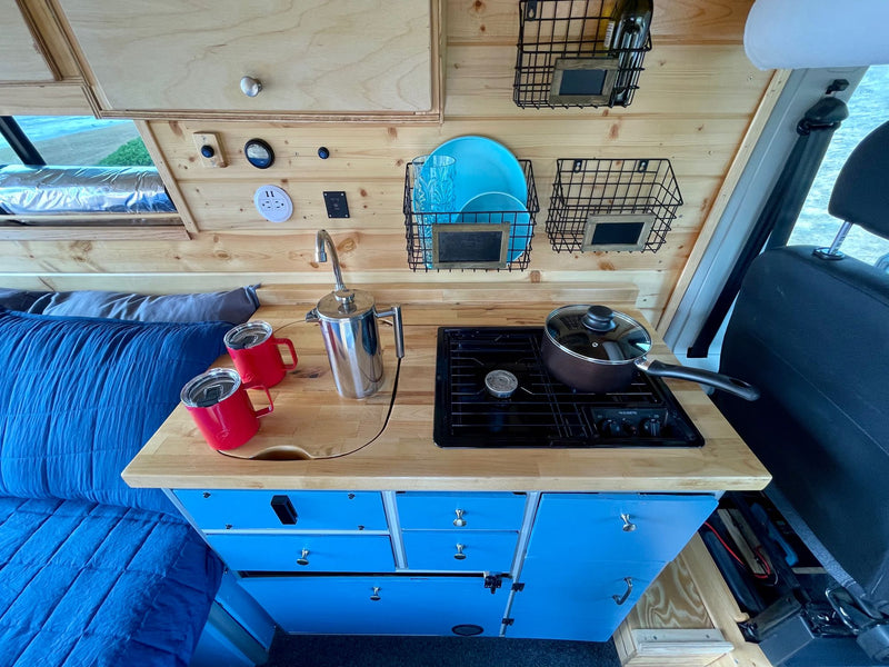 parked right on a sandy beach overlooking the ocean view.|This cozy RV rental's kitchen — photo 4