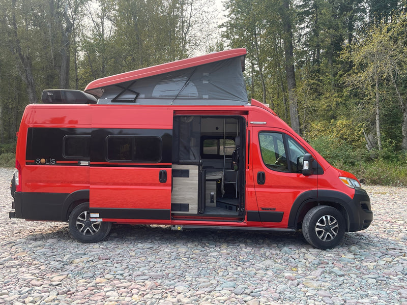 Eye-catching red Winnebago Solis pop-top RV rental with open side door — photo 1
