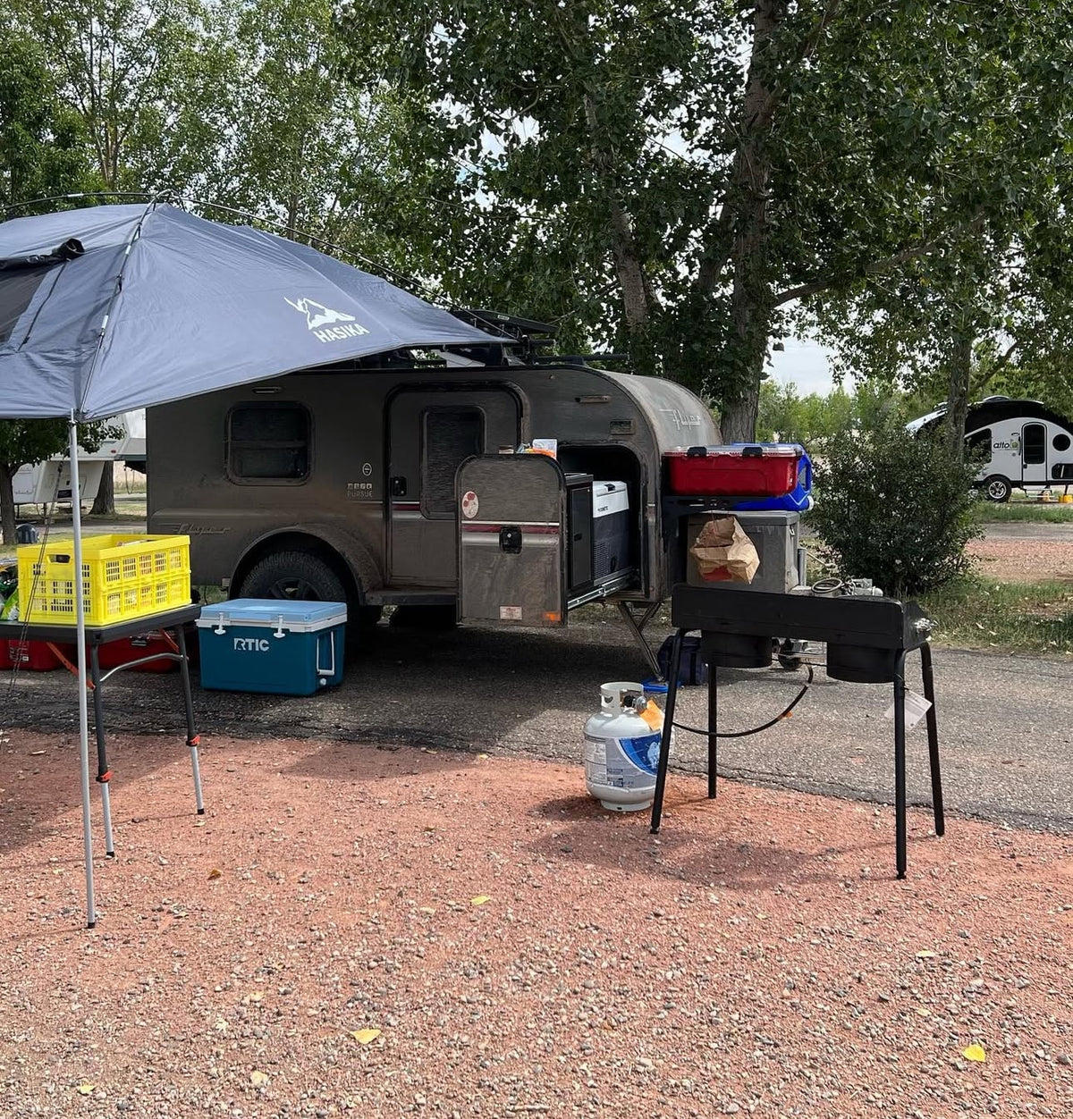 An RV rental campsite with a compact trailer