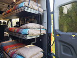 RV rental interior: three stacked bunk beds with colorful bedding, maximizing sleeping space in a comfortable camper van.