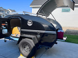  silver and black 'COUNTRY BORN MODERN BUGGY' travel trailer