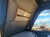 Experience beachfront camping in this RV rental rooftop tent with a comfy mattress, storage pockets, and ocean views.