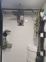 Enjoy a modern RV rental shower! Features a rain shower, handheld, and organized shelves for toiletries.
