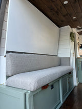 Spacious RV rental interior with convertible bench seating, ample storage, and warm wooden ceiling.