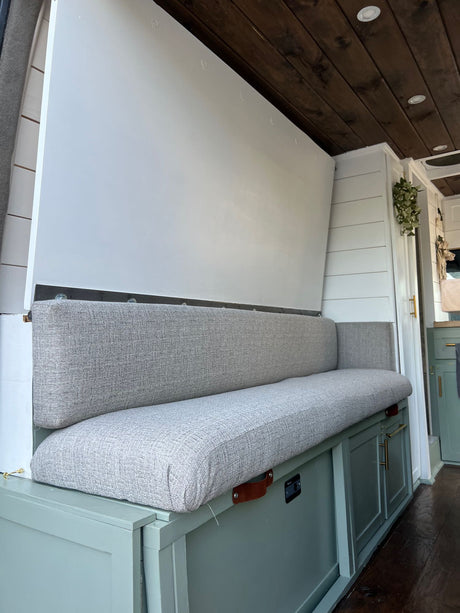 Spacious RV rental interior with convertible bench seating, ample storage, and warm wooden ceiling.