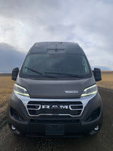 Front view of a grey Winnebago RV rental on a dirt road, ideal for scenic road trips.