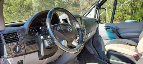 Driver's view of a modern RV rental: Mercedes-Benz cockpit with a sleek dashboard. Ready for your next journey.
