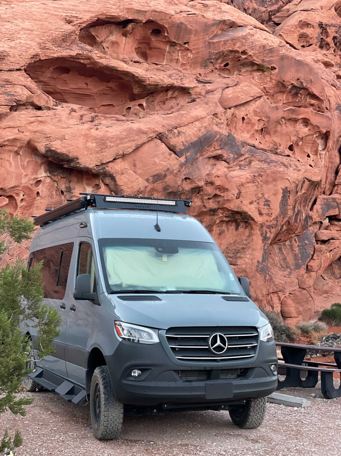Rugged Mercedes Sprinter van, ready for adventure among red rocks. Ideal for an RV rental experience.