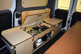 Inside an RV rental: a compact camper van kitchen unit with sink, utensils, and storage for road trip cooking.