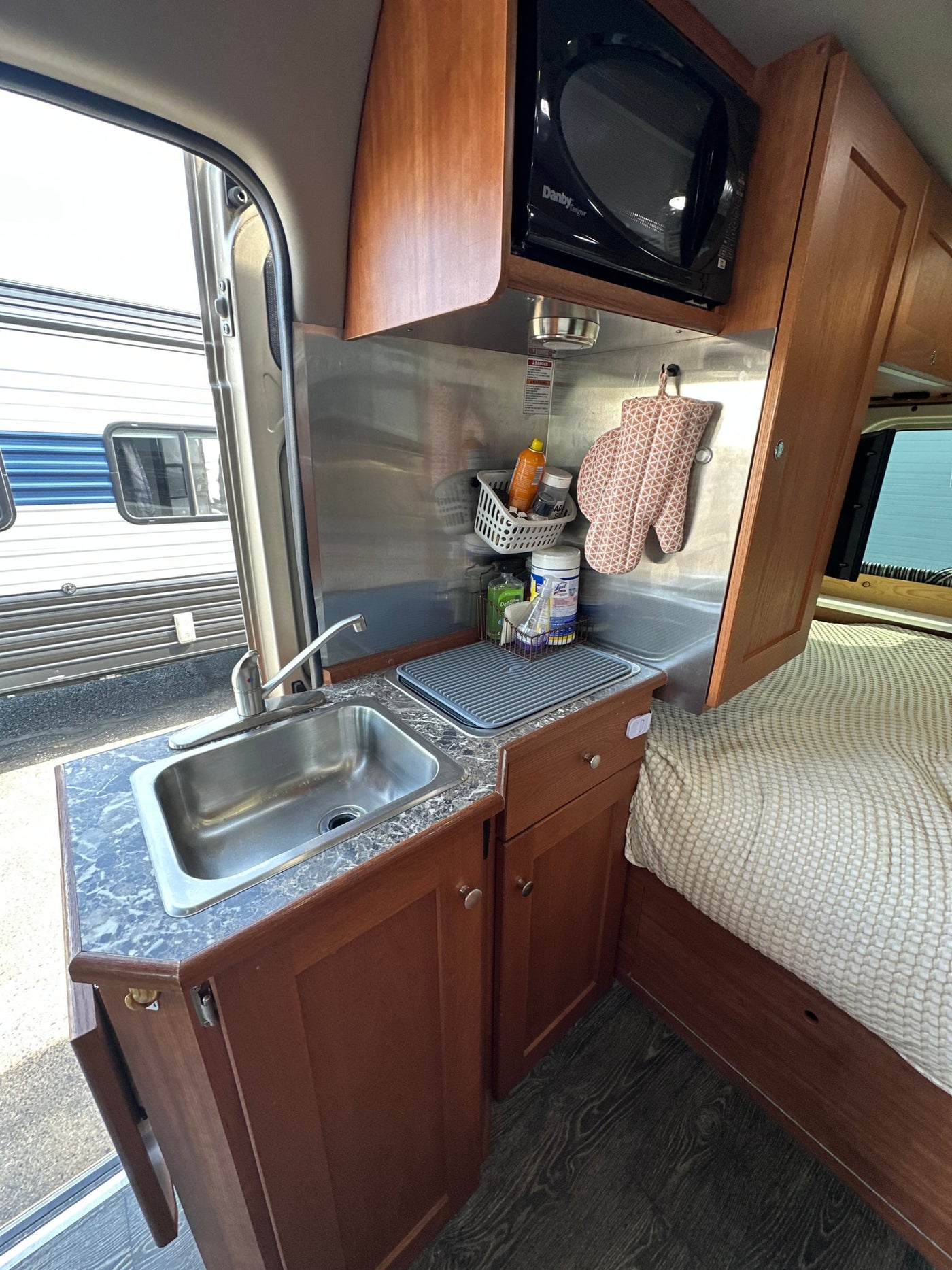  parked outdoors.|RV rental interior: A comfortable bed — photo 8