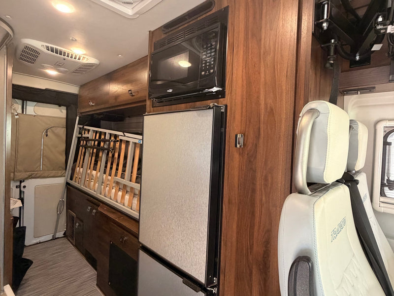  and practical overhead storage.|Modern RV rental interior: kitchenette — photo 4
