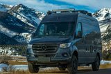 This dark grey Mercedes Sprinter **RV rental** with off-road tires is perfect for mountain adventures.