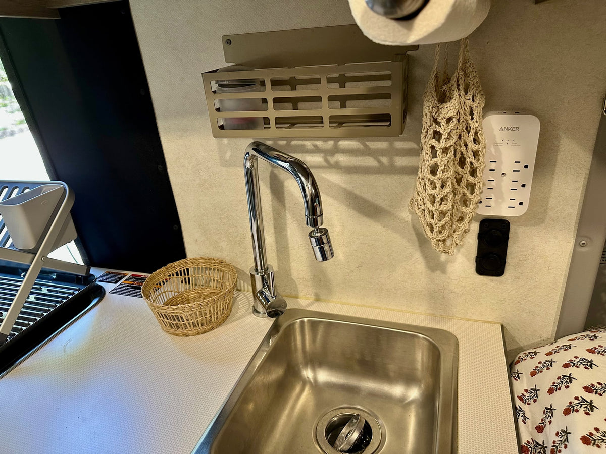  showing interior details.|Cozy RV rental bed with floral sheets — photo 15