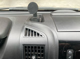 Dashboard view inside an RV rental, showing a magnetic phone mount, air vents, and screen controls. Typical vehicle interior.