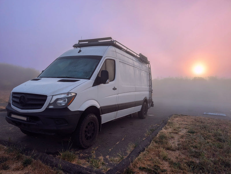  and driver's cabin seats with blue pillows.|Compact RV rental kitchen & full shower. This efficient layout offers comfort for your mobile adventures.|RV rental interior blueprint: functional layout with bed — photo 13