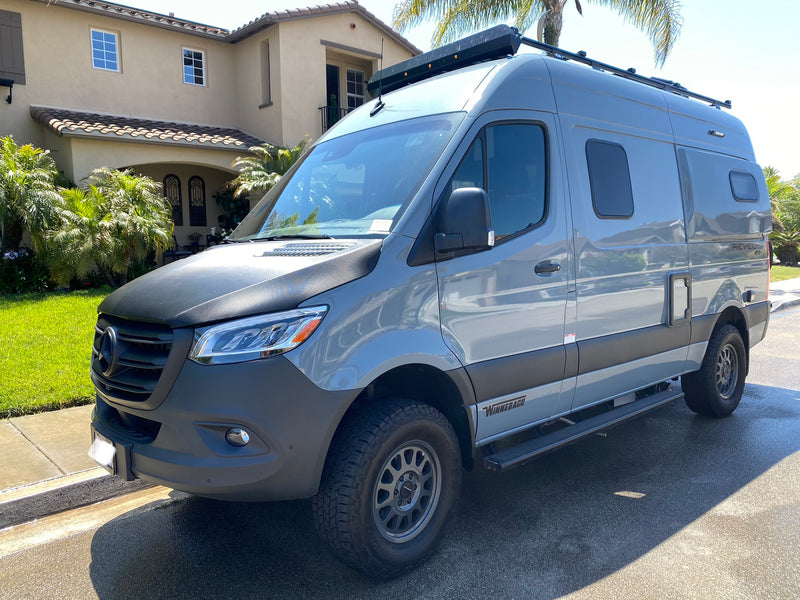 A sleek gray Winnebago Revel 4x4 camper van, parked on a sunny day, ready for your next RV rental adventure. — photo 1