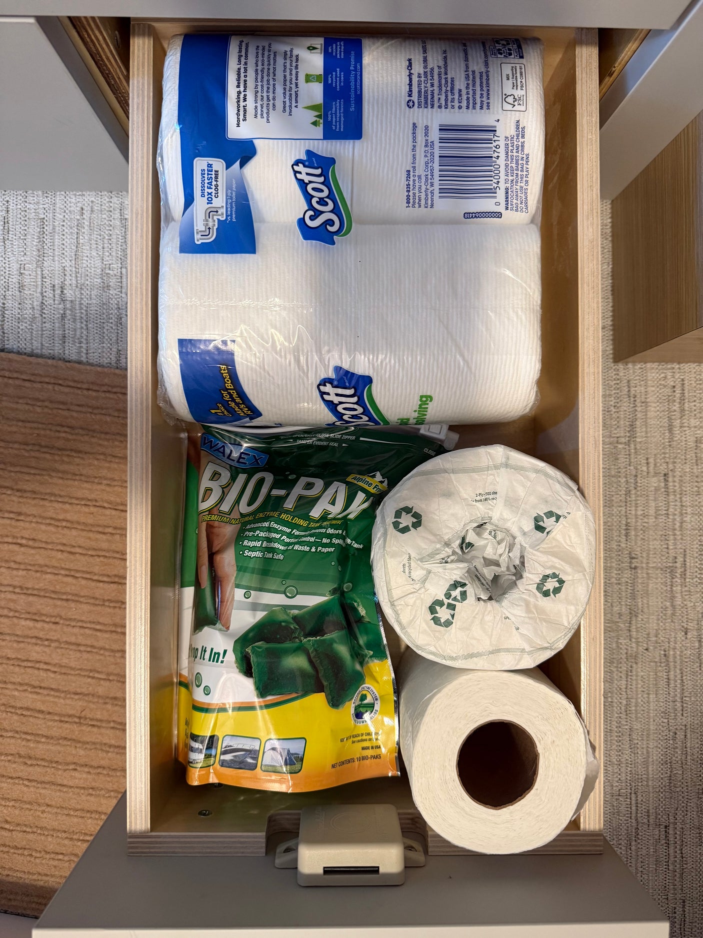 RV rental drawer with Scott rapid-dissolving toilet paper and Walex Bio-Pak holding tank treatment. Travel essentials.