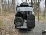 Adventure-ready gray Sprinter van with rear ladder, spare tire, and cargo box. Great for your next RV rental trip!