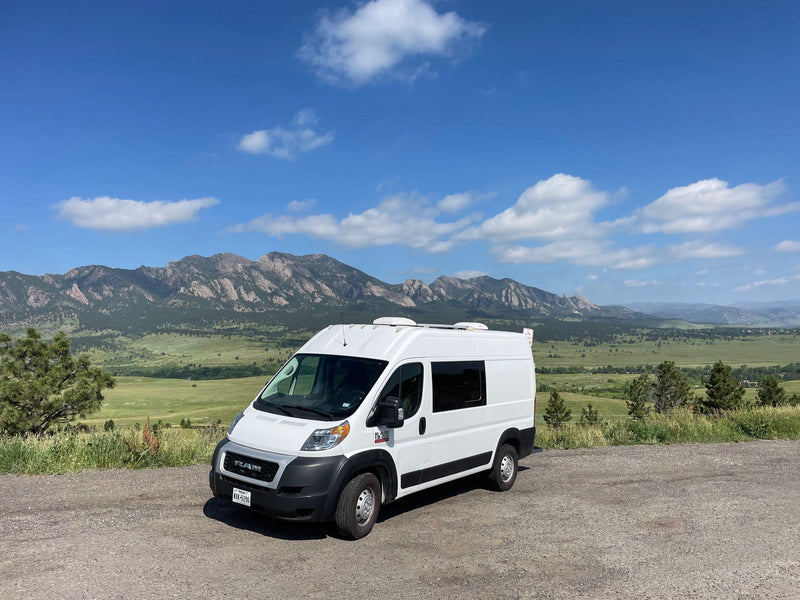 White rv rental campervan on a gravel road — photo 1