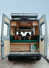 Explore van life! This rv rental features a custom wood interior with a cozy bench seat & ocean views.