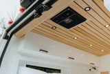 Step inside this rv rental's cozy interior, featuring a stylish wood-slat ceiling, integrated AC, and crisp white overhead cabinets.