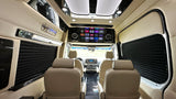 Inside a luxurious **rv rental**: cream leather seats, a large entertainment screen with apps, and sleek interior design for premium travel.