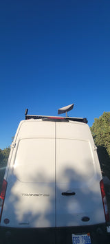 White Ford Transit 250 van, an rv rental, with a roof rack & satellite dish. Perfect for remote work & travel adventures.