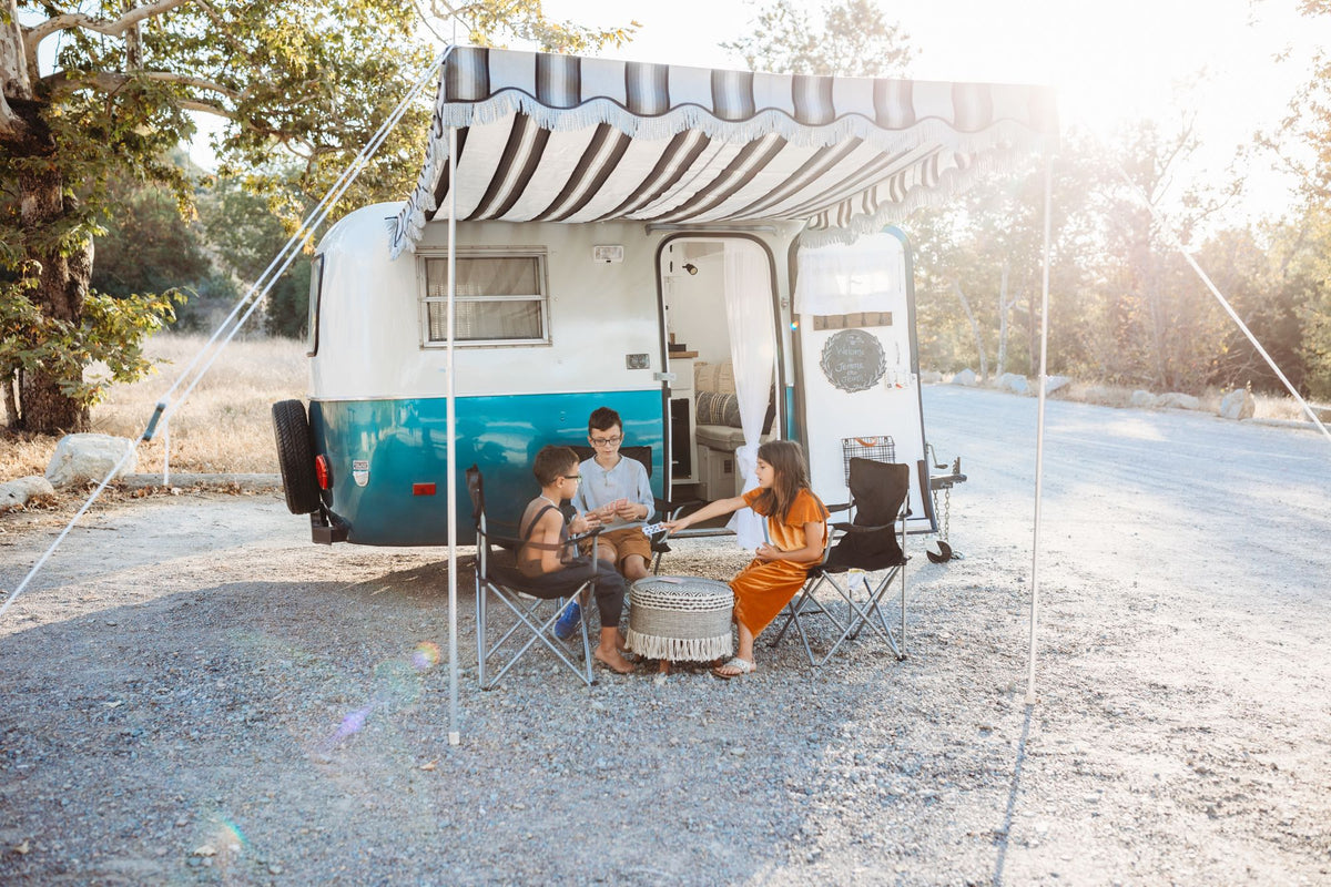 Three kids enjoy a family camping trip